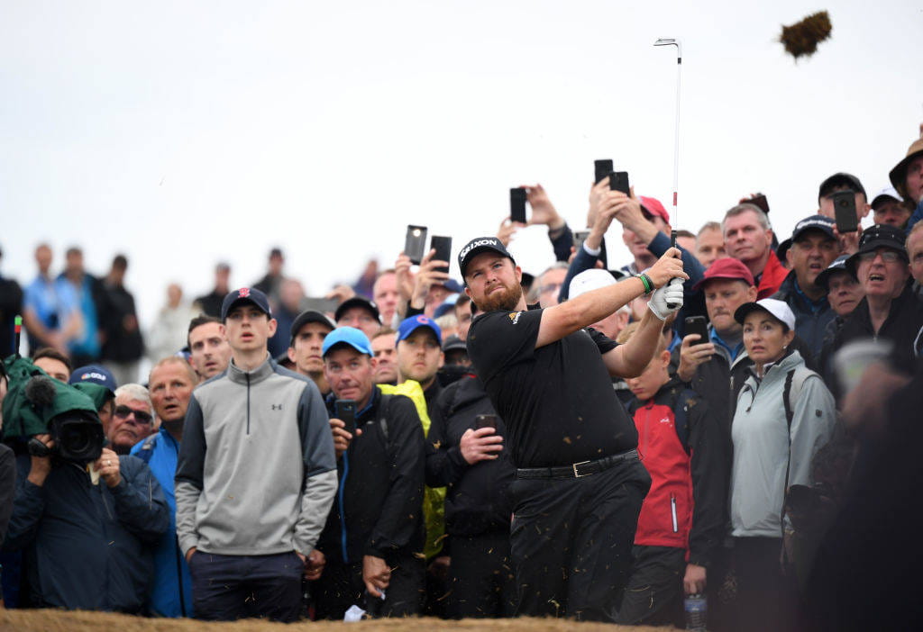 Shane Lowry hitting a shot in front of a huge crowd
